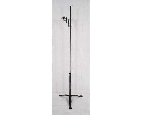 An antique style wrought iron rush light candle holder on tripod base - height 158.5cm