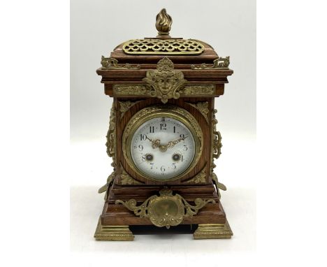 A turn of the century French oak and gilt brass bracket clock with enamel dial and Arabic numerals, marked "Medaille de Bronz