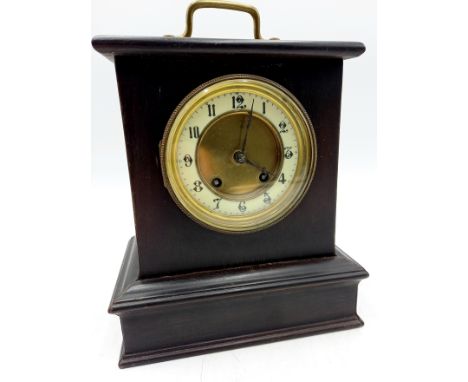An Edwardian ebonised case mantle clock with brass carrying handle,21cm wide 24cm high.