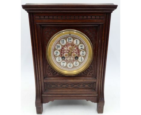 An Arts & Crafts oak cased chiming mantle clock with painted dial and carved decoration to case, 31cm high.