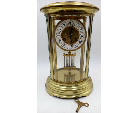 A Richard & Cie oval four glass mantle clock, with enamelled dial and mercury pendulum, 36cm high.