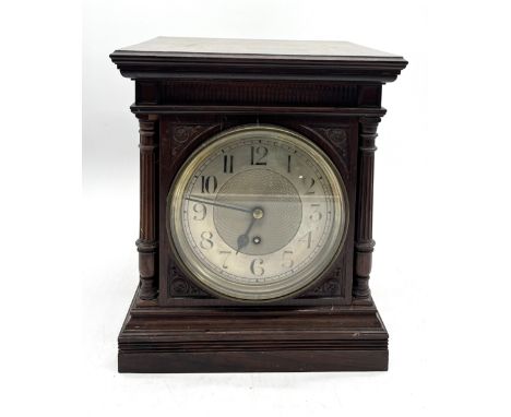 A heavy English made rosewood cased bracket clock with column detail, silvered dial and fusee movement 