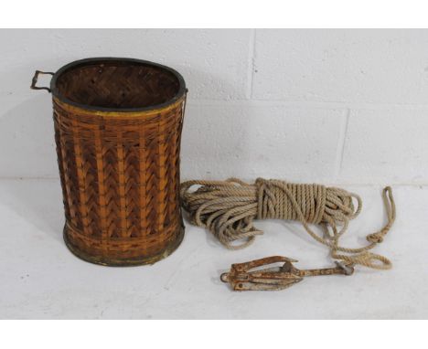 An antique wicker and brass stick stand, along with a grappling hook marked 'SAV, Norway'