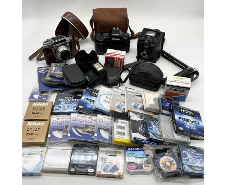 A collection of vintage cameras, filters and accessories including Nikon F90X, EXA 1a and an Ensign Ful-Vue 