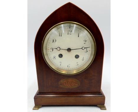 An Edwardian mahogany arch cased mantle clock with shell patera inlay, on brass bracket feet, 18cm wide, 25cm high.