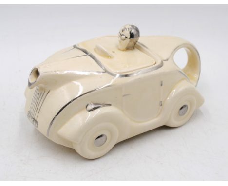 A vintage Saddler OKT42 ceramic teapot in the form of a racing car with cream with silver lustre trim and marks to base