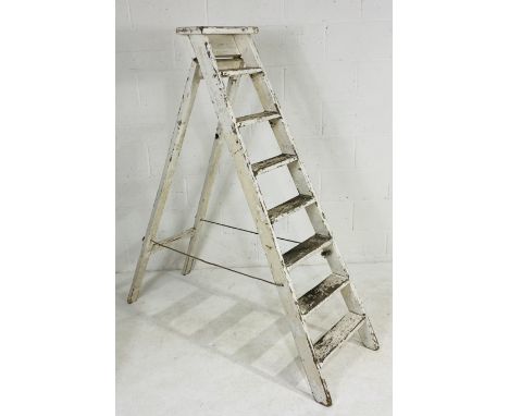 A vintage white-painted step ladder