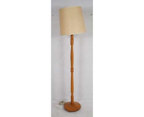 A turned oak standard lamp, with shade