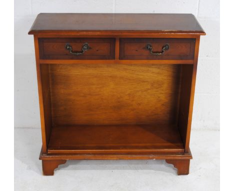 A wooden freestanding bookcase, with two drawers over, raised on bracket feet - length 76.5cm, depth 28.5cm, height 78cm