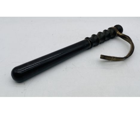 A vintage policeman's wooden truncheon with original strap, marked Devon Constabulary