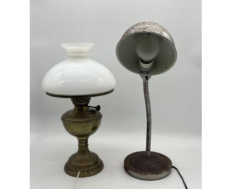 A vintage oil lamp converted for electric use along with a modern desk lamp with rust patina 
