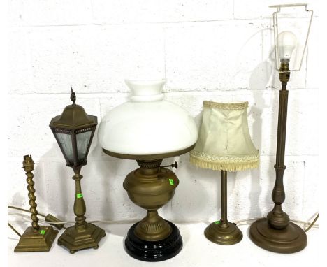 Five antique and later brass lamps including a converted oil lamp, etc.