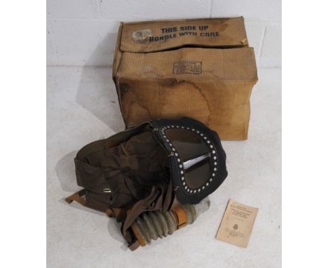 A boxed WWII baby's gas mask, with manual dated 1940