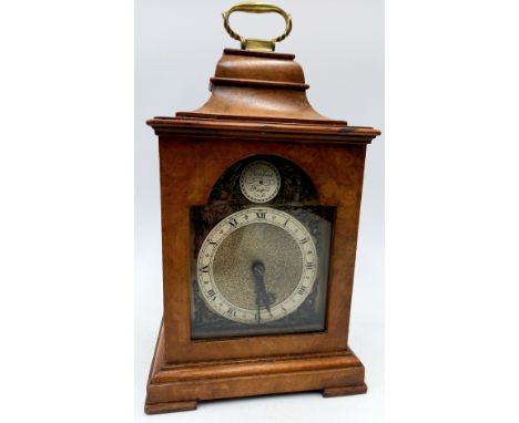 A Swiss Bruen walnut cased small bracket clock with brass handle, 23cm high.
