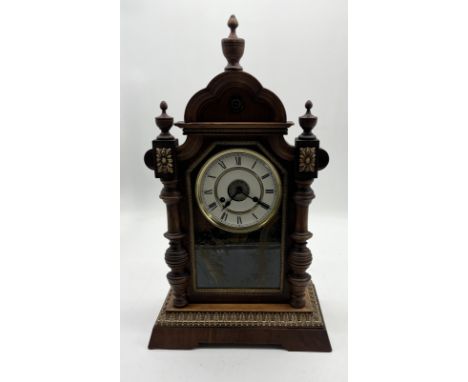 A Junghans mantle clock, small crack to glass panel as shown.   