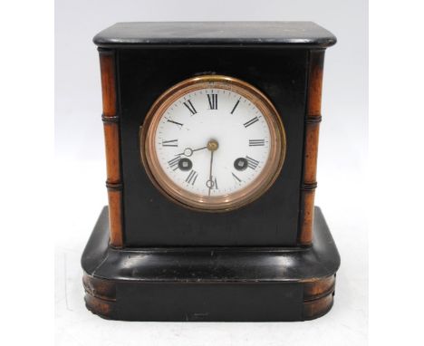 An antique French wooden mantle clock, with bamboo detailing 
