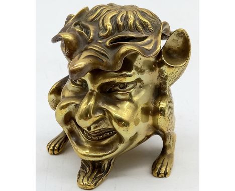 A 19th century brass grotesque, anthropomorphic devil or imp design inkwell, 9cm high, 9cm diameter.