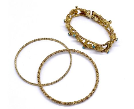 A vintage gold tone bracelet set with turquoise-coloured stones along with two Middle Eastern bangles.