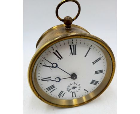 An antique brass barrel alarm clock,10 cm diameter.