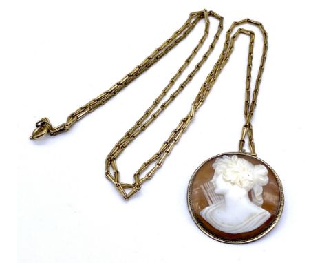 A vintage carved shell cameo brooch/pendant on gold plated chain 75cm length.