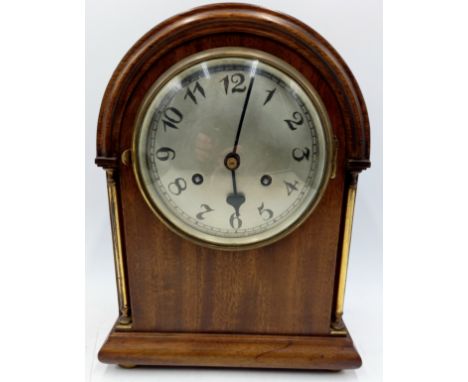 A mahogany cased large strike mantle clock with brass pillars, 33cm high on brass bun feet.