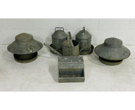 A collection of vintage galvanised chicken feeders and watering can