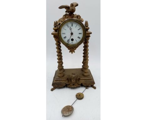 A French gilded metal mantle clock with bird finial, 34cm high.