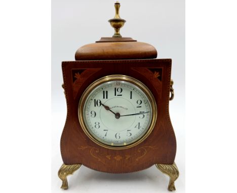 An Edwardian mahogany and inlaid cased Walker & Hall Ltd mantle clock, on brass cabriole legs, 17cm wide, 26cm high.