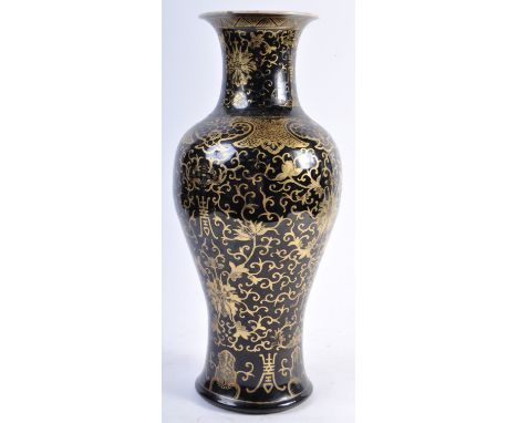 An 18th Century Chinese antique Kangxi mark black mirror glaze vase of baluster shape having hand gilded scrollwork with flor