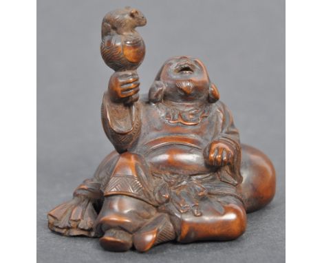 A fine Japanese believed Edo period / 19th century carved wooden signed netsuke. The netsuke in the form of Daruma, in typica