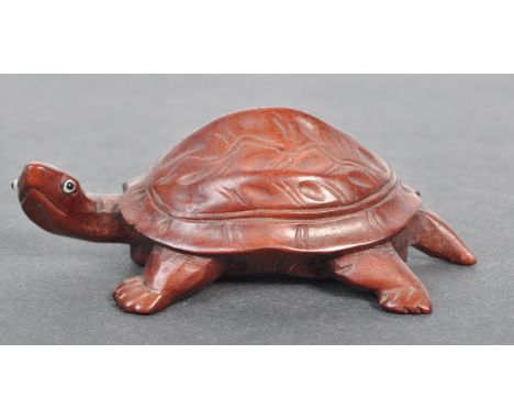 A fine Japanese believed Meiji period / 19th century carved wooden signed netsuke. The netsuke in the form of a tortoise / tu