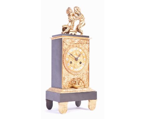 A 19th Century French antique mantel clock having two ormolu bronze figurines of cherubs to top with front ormolu panel embos