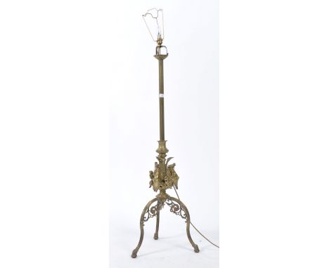 An antique Victorian 19th century brass architectural standard floor lamp having arched tripod leg&nbsp; base with a stunning