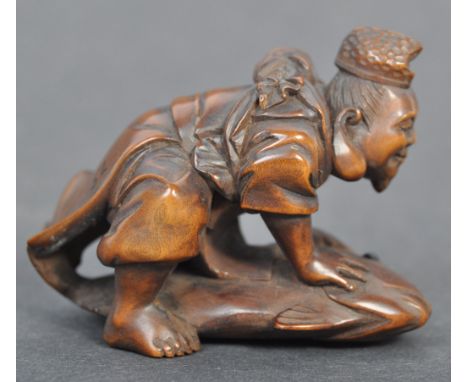 A fine Japanese believed Edo period / 19th century carved wooden signed netsuke. The netsuke in the form of Ebisu atop a Tai 