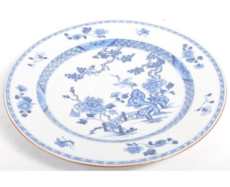 A late 19th Century Chinese Qing Dynasty antique blue and white charger plate having Kangxi style decoration. The border with