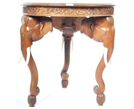 An early 20th Century&nbsp;Anglo Indian antique inlaid elephant side occasional table of round form. The top heavily carved h