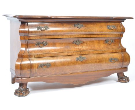 A 19th Century Dutch antique walnut commode chest of drawers of bombe shape having a carved serpentine shaped top raised over