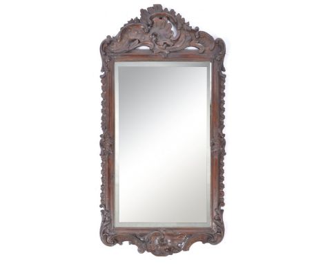 An antique 19th century Victorian mahogany architectural rococo worked pier mirror. Of rectangular form with stunning rococo 