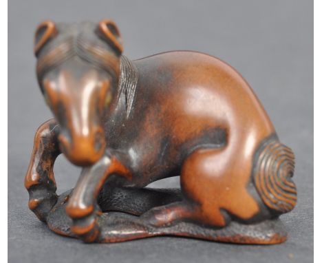 A fine Japanese believed Edo period / 19th century carved wooden signed netsuke. The netsuke in the form of a recumbent horse