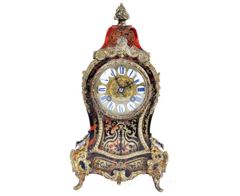 AD Mougin of Paris - A 19th Century French antique boulle work tortoiseshell mantel clock having intricate brass inlay scroll