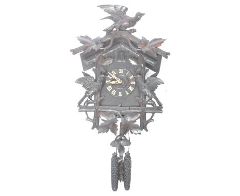 A superb 19th Century Victorian English antique Black Forest&nbsp;cuckoo clock. The wall hanging clock surmounted by a crow a