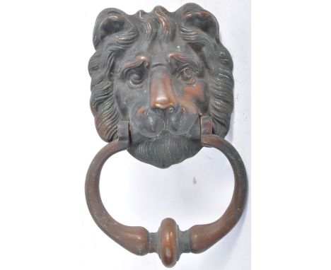 A 19th Century English / French heavy antique bronze architectural door knocker in the form of a lions head having detailed f