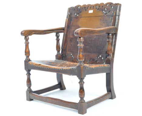 A 19th Century Victorian English antique oak monks chair / settle bench seat having a carved pierced decorated foldover top a