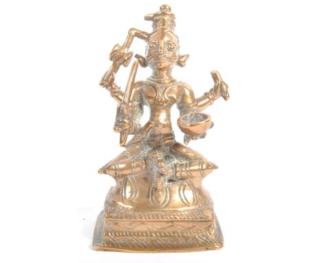 A 19th Century Indian Hindu bronze figurine of a four armed deity holding skull pot, drum or wheel, sword and another. Modell
