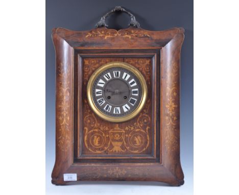 An Edwardian rosewood and inlaid bronze handled framed wall clock having a central raised rectangular body with inset round f