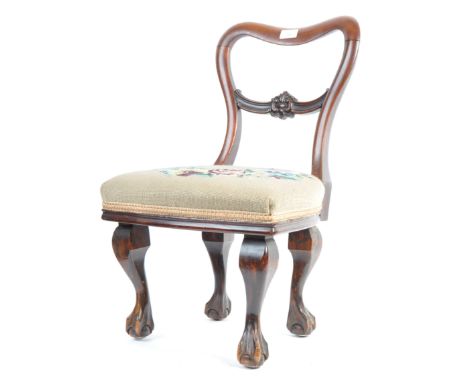 A charming 19th Century Victorian English antique mahogany childs chair / childrens chair having a carved 'C' scroll back rai