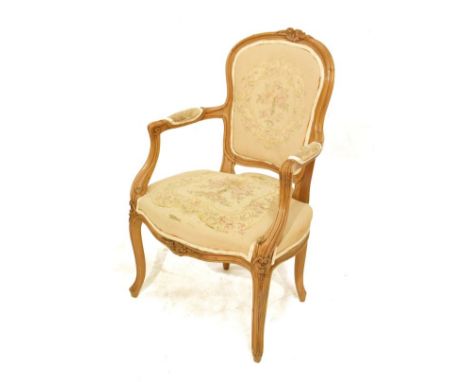 French carved walnut fauteuil or open arm elbow chair, the seat and back upholstered in simulated tapestry and standing on ca