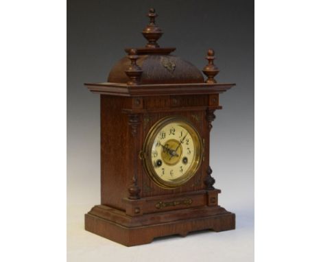 Early 20th Century bronze brass mount oak architectural style mantel clock, the brass dial having an off-white chapter ring w