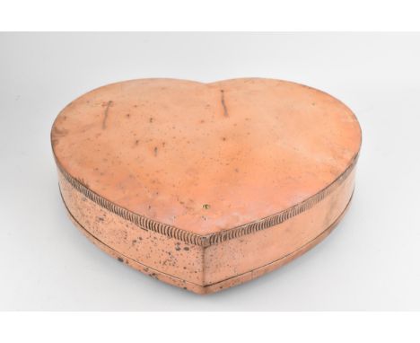 A large 19th century copper, heart shaped box/mould, the screwed down lid having a milled edge on three button feet, 9.5cm h,