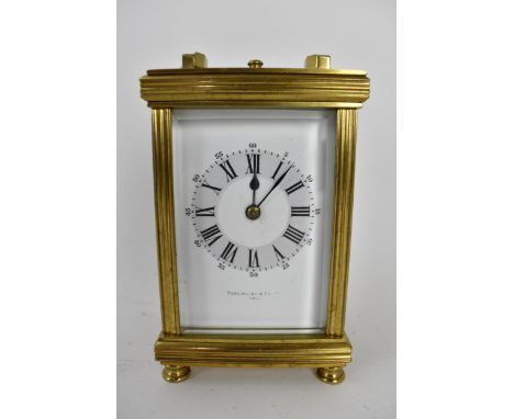 A late 19th/early 20th century brass cased repeater carriage clock having a white enamel dial with Roman numerals and signed 